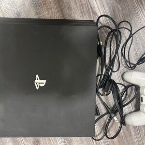 PS4 Pro with one controller and 5 games with travel bag